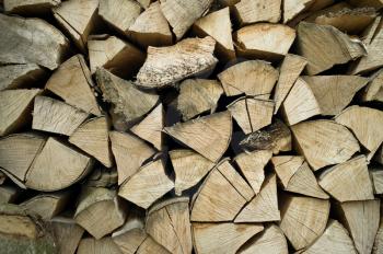 Closeup of chopped firewood. Firewood stacked and prepared for winter Pile of wood logs.