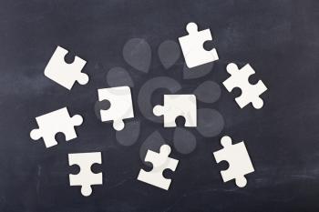 Business solution concept - jigsaw on the blackboard
