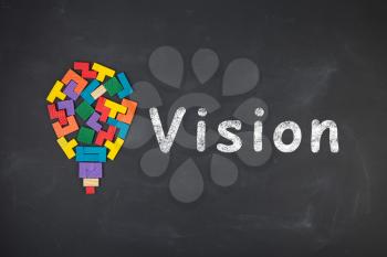 Business Vision concept - inscription and jigsaw blocks on the blackboard