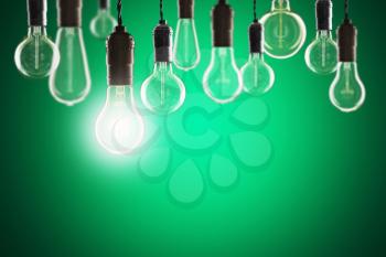 Idea and leadership concept - Vintage bulbs on the color background