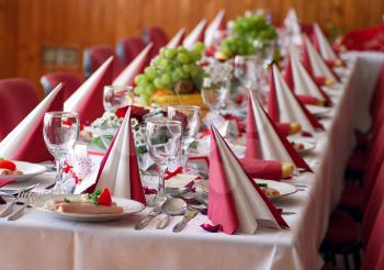 Wedding table covered by red table cloth.