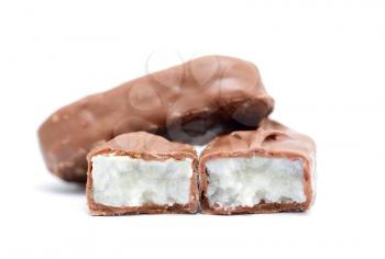 Front view on sliced coconut chocolate bar on a white background.