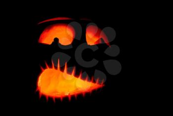 Shining scary halloween pumpkin face at night.