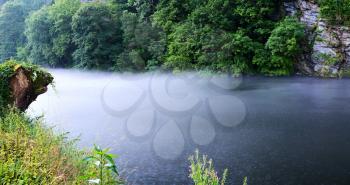 View on foggy river during rain.