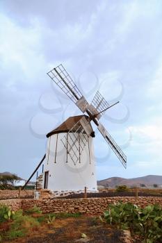 View of traditional windmill against blue sky in Fuerteventura island.