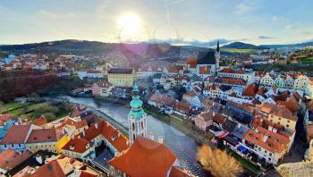 Panoramic aerial view of beautiful town Cesky Krumlov with Vltava river, photo taken against the sun.