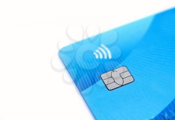 Close up of blue credit card with chip and contactless sign on white background.