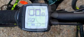 Electric bike control unit with display showing distance of trip in kilometres.
