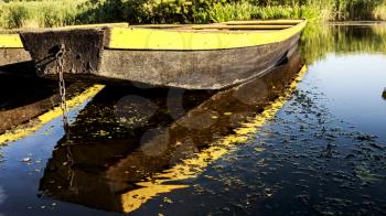 Row boat floating on the waterand and reflects in it