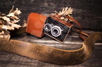 Vintage photo camera on a wooden surface