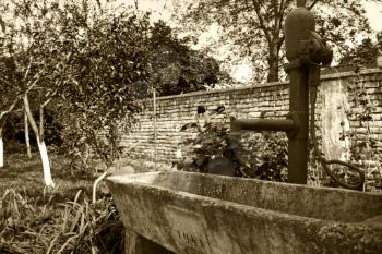 Old Rustic Hand Water Pump at The Well in the Garden