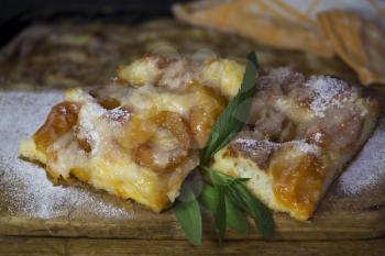 Apricot Cake With Mint Leaves On a Rustic Wooden Board