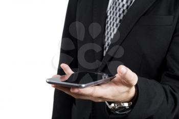Businessman in Back Suit and Tie Holding Smartphone in Hand Against White Background