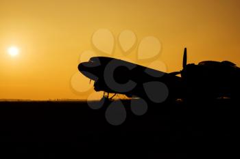 Silhouettes of Airplanes at the airport at Sunset