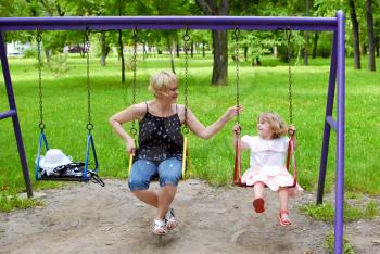 happy mother and daughter in the playground