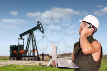 oil worker with laptop and phone