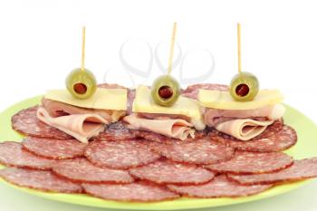 salami ham cheese and olives on dish