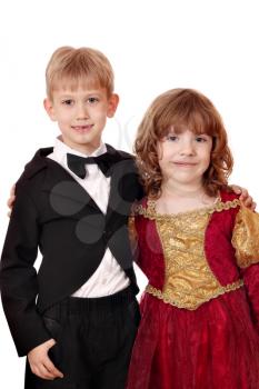 boy in tuxedo and little girl in golden red dress portrait