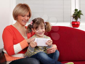 happy mother and daughter with tablet pc family scene