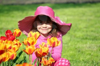 beautiful little girl with tulip flowers portrait