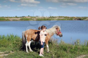 beautiful little girl with pony horse