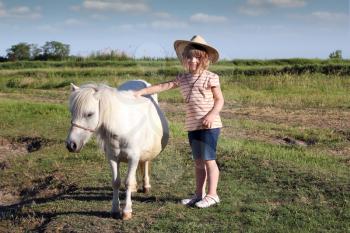 child little cowboy and pony horse 
