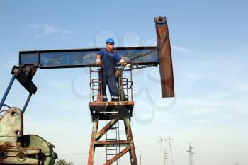 oil worker on pump jack