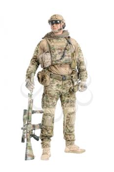 Full length low angle studio shot of big muscular soldier in field uniforms with sniper rifle, portrait isolated on white background lot of copyspace. Protective goggles glasses are on
