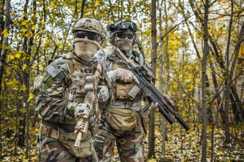 Two United states Marine Corps special operations command Marine Special Operators also known as Marsoc raiders in camouflage uniforms in the forest
