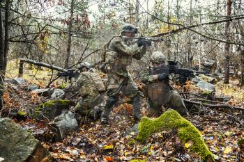 Norwegian Rapid reaction special forces FSK soldiers in field uniforms in action in the forest among the rocks