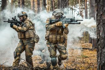 Norwegian Rapid reaction special forces male and female FSK soldiers in field uniforms in action in the forest fog