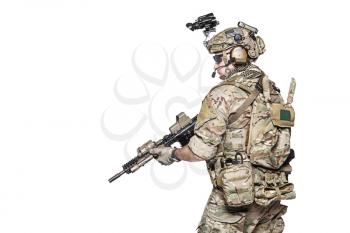 Elite member of US Army rangers in combat uniforms with his shirt sleeves rolled up, in helmet, eyewear and night vision goggles. Studio shot, white background
