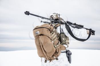 Army soldier with Sniper rifle in action in the Arctic. Back view