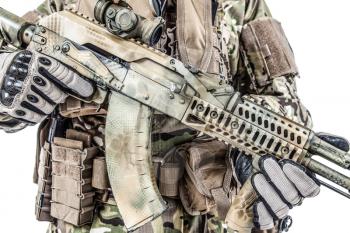 Close-up shot of Kalashnikov rifle automatic weapons in hands of army special forces soldier isolated on white background