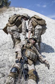 US marines evacuate the injured fellow in arms in the mountains