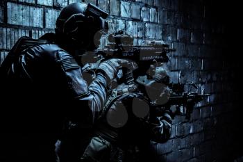 Pair of soldiers in action under cover of darkness