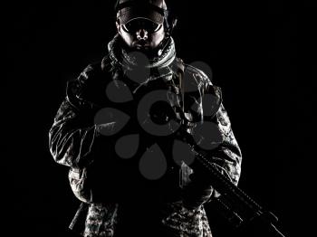 Studio shot of United States Marine with rifle weapons in uniforms. Military equipment, army helmet, combat boots, tactical gloves. Isolated on black, weapons, army, patriotism concept