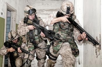 Marine assault team, counter-terrorism squad members, commando fighters in body armor, armed with service rifles, stalking through corridor to closed door, clearing rooms in abandoned city building
