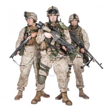 Full length group portrait of army special operations forces soldiers, marines in combat uniform and tactical ammunition, armed with service rifle, shotgun and middle machine gun isolated studio shoot