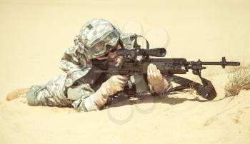 United states airborne infantry marksman in action in the desert, pointing the enemy. High accuracy firing concept, toned colorized shot