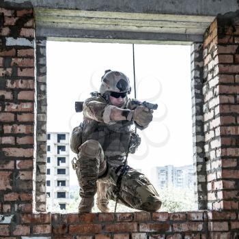 Soldier during assault rappeling exercises with weapons