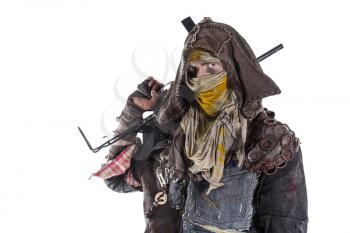 Nuclear post apocalypse life after doomsday concept. Grimy survivor with homemade weapons. Studio closeup portrait on white background