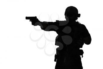 United states Marine Corps special operations command Marsoc raider with weapon aiming pistol. Silhouette of Marine Special Operator white background