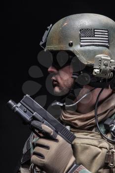 United states Marine Corps special operations command Marsoc raider with pistol. Studio shot of Marine Special Operator black background