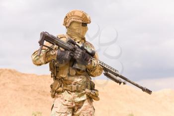 Close-up photo of special force soldier with sniper rifle
