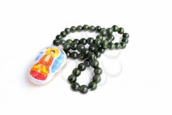 Green Chinese beads with medallion on white background.