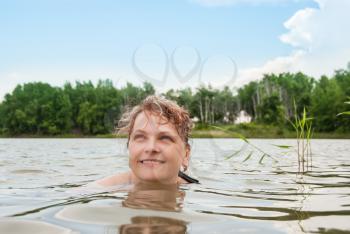 Close up of a woman's face swimming in the lake