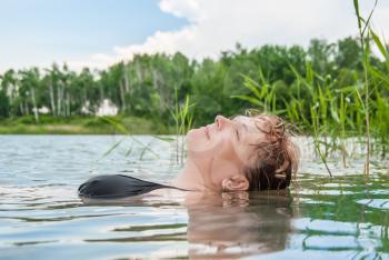 The woman blindly swims in the lake