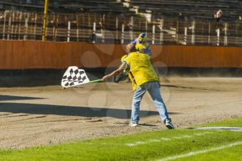 lLviv, Ukraine - 17 April 2016:  Man with a checkered flag indicates the finish at the  Flat Track  National Championship  to the Lviv city