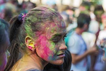 Lviv, Ukraine - August 30, 2015: Girl  watching festival of colors in a city park in Lviv.